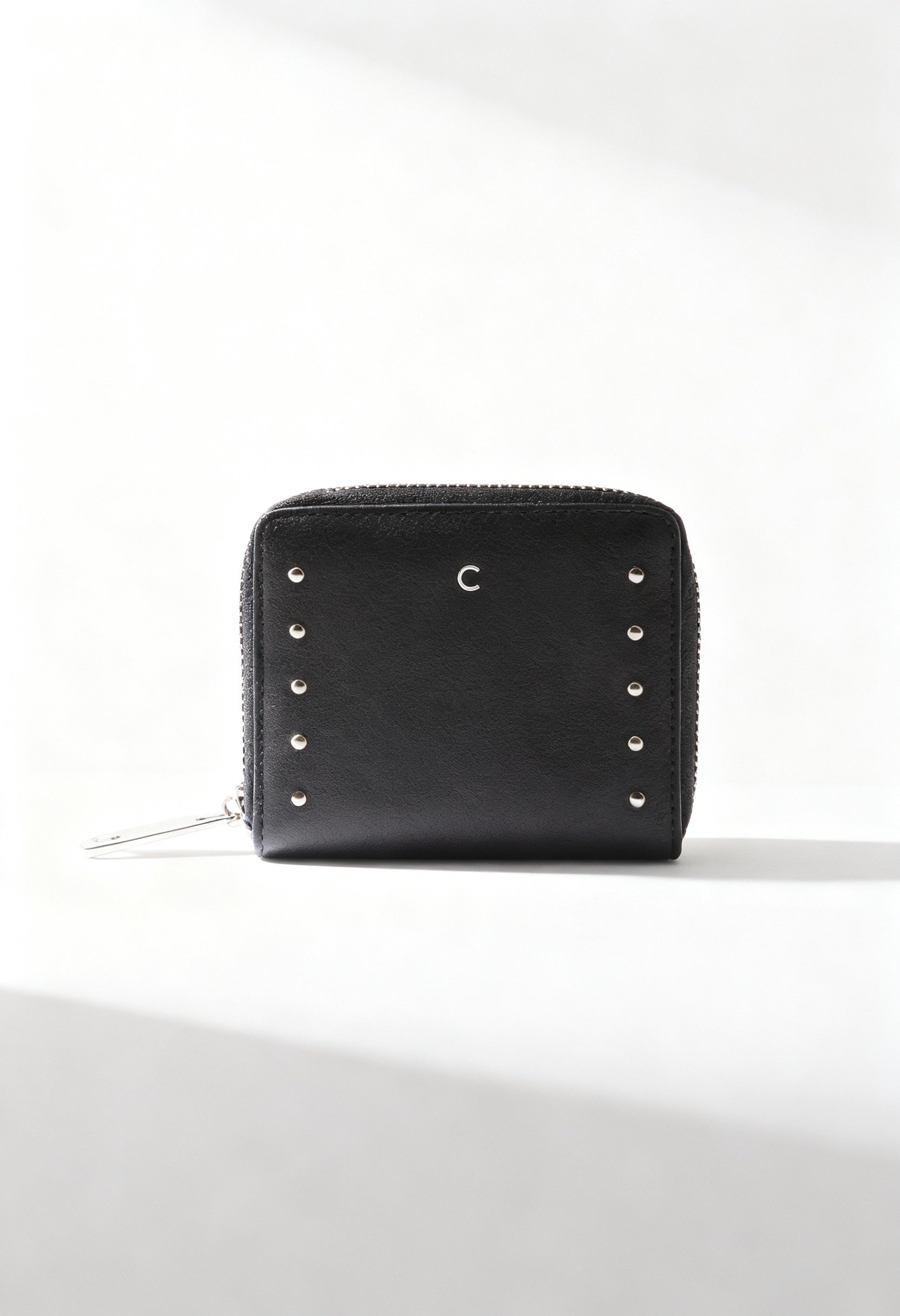 Carrera Jeans ALLIE-CB7053 black women’s studded PU wallet with zip closure, displayed in bright studio lighting.