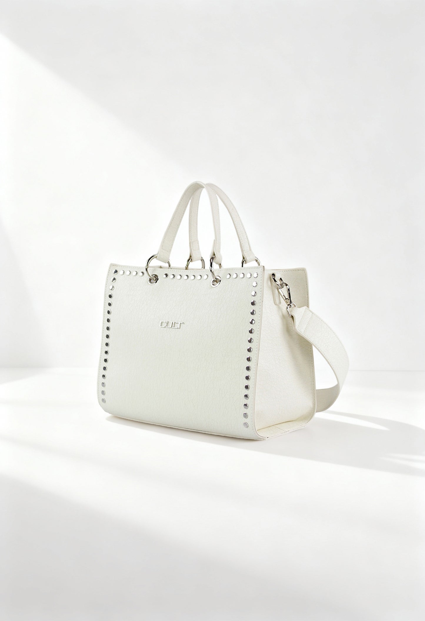 Cult X3EPWX090012 white studded handbag with dual handles and removable strap, displayed in bright studio light.