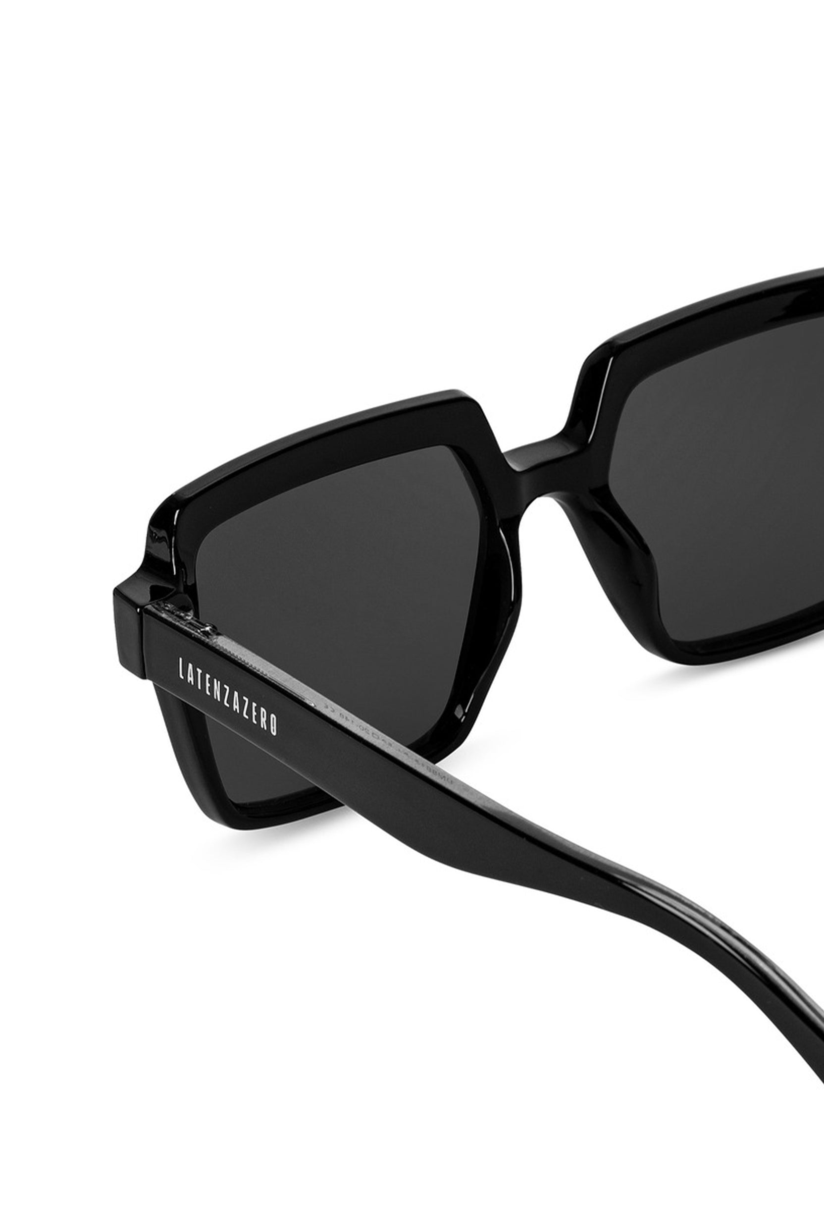Close-up detail of LatenzaZero Echelon sunglasses showing glossy black acetate frame and UV3 protective lenses.