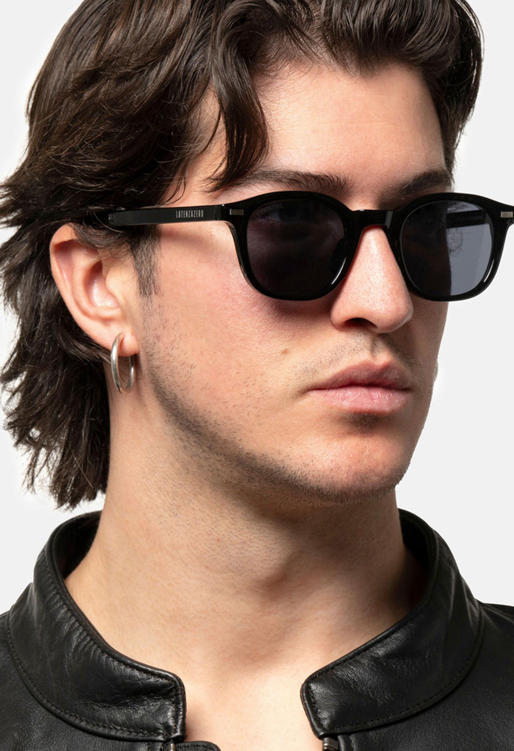 Profile of male model wearing LatenzaZero Zenith sunglasses with black acetate frame and dark UV3 lenses.