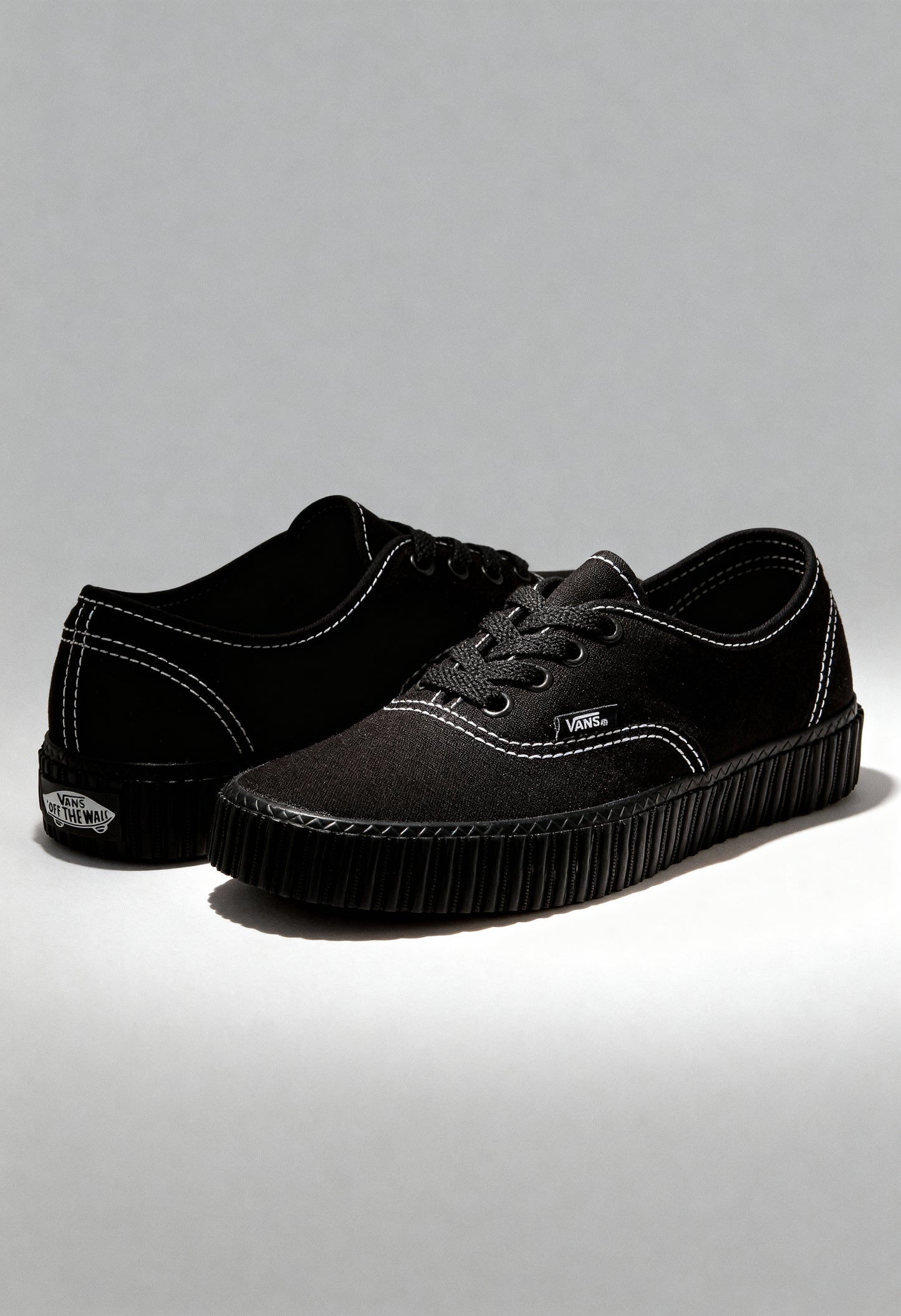 Black Vans VN000CR2BLK1 unisex sneakers displayed in studio lighting with canvas upper and rubber sole.