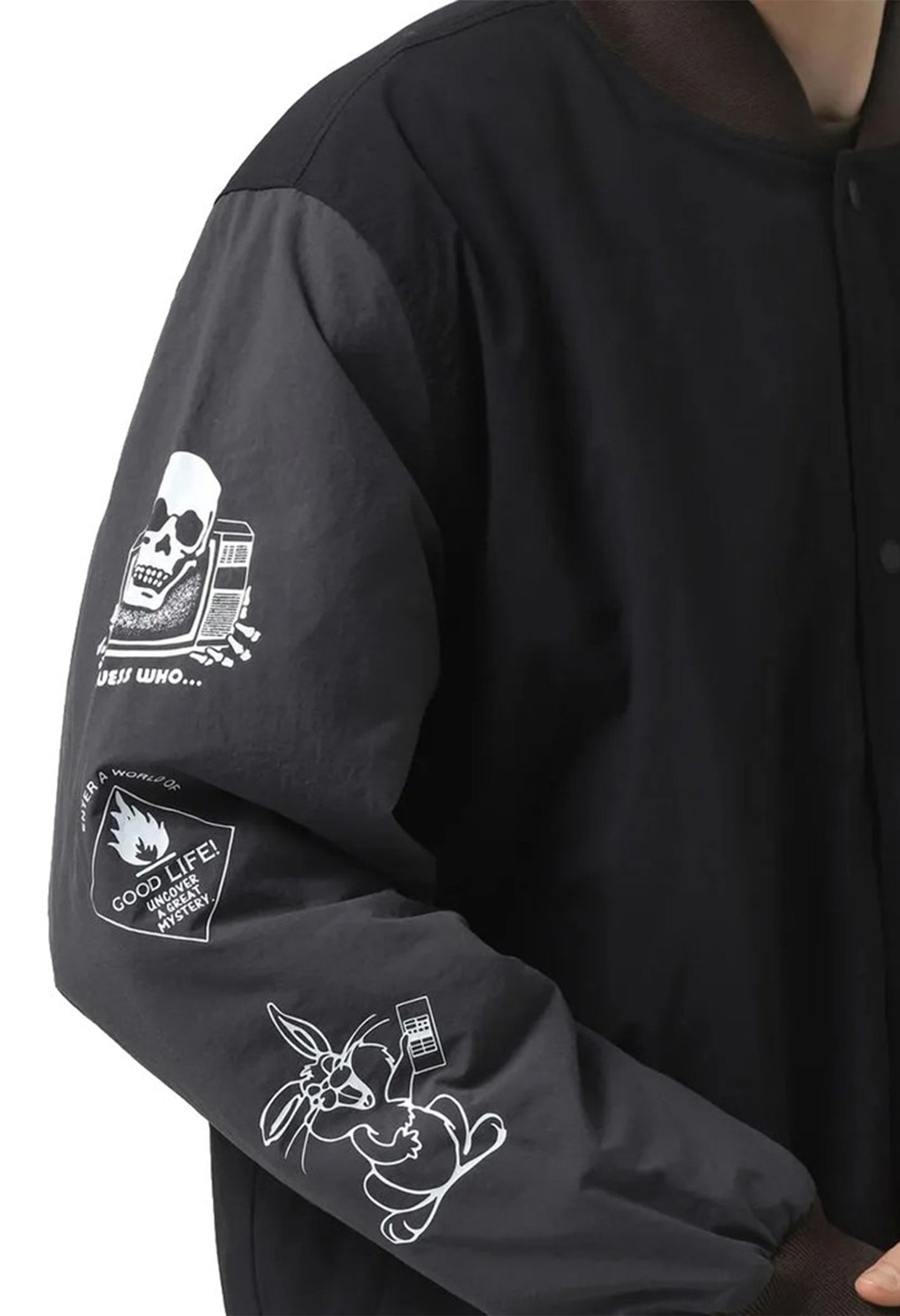 Close-up of Vans VN000JY1KOU1 jacket sleeve showing white printed graphics and nylon texture.