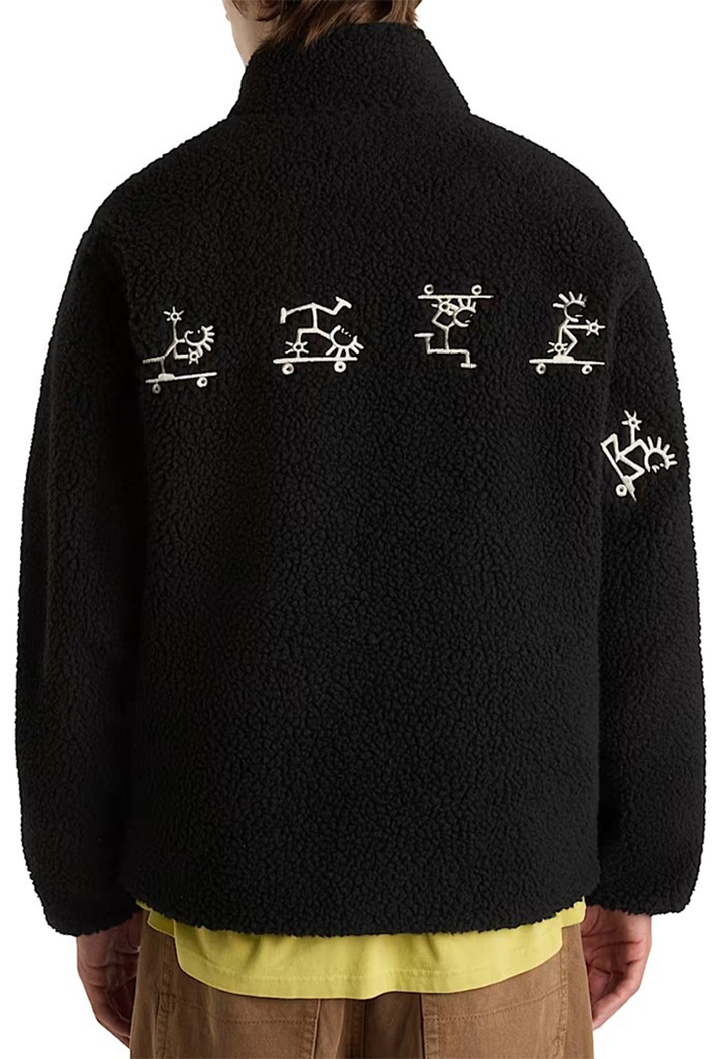 Back view of Vans VN000NDUBLK1 men’s fleece jacket featuring white graphic details across the upper back.