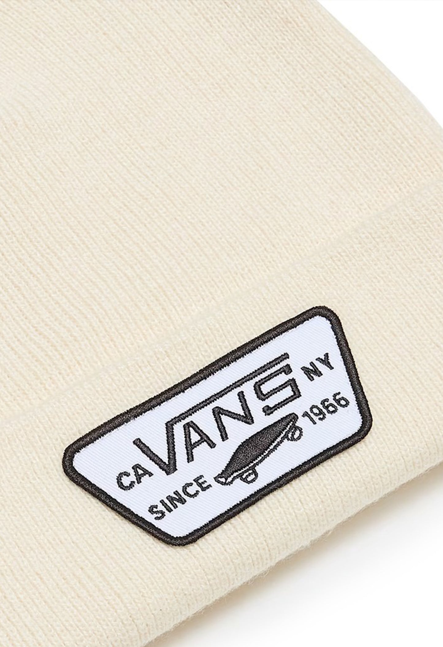 Close-up of Vans VN000UOUDJR1 beanie hat showing Vans NY woven patch on cream knit cuff.