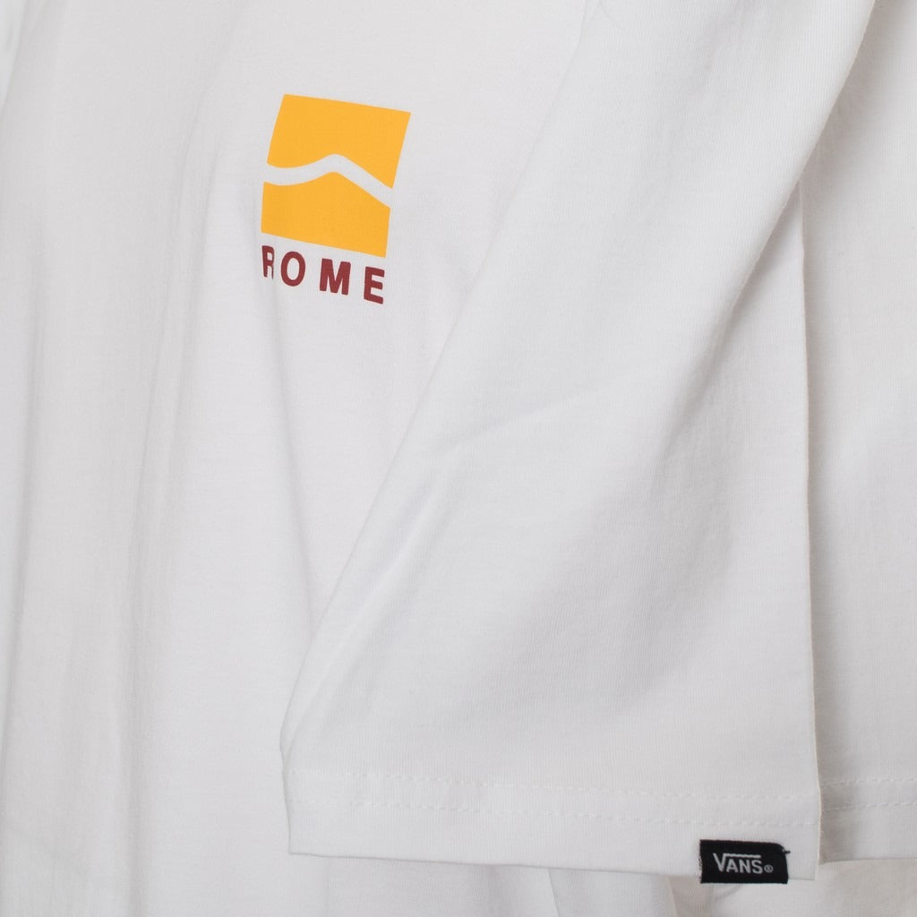 Close-up of Vans VN0A4CYDWHT1 yellow front chest logo printed on white cotton fabric.