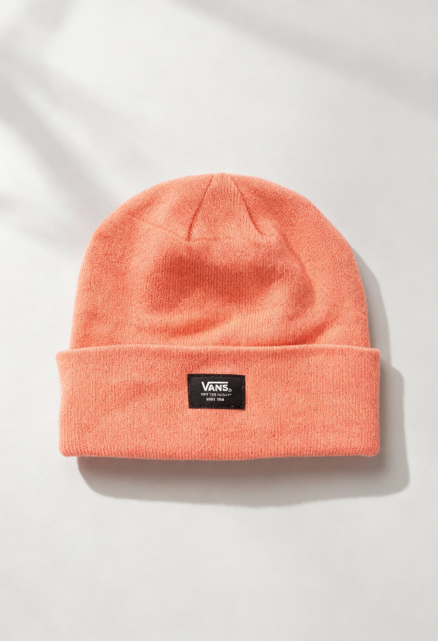 Vans VN0A5GPLQID1 solid orange unisex beanie hat displayed flat with woven Vans logo patch on cuff.