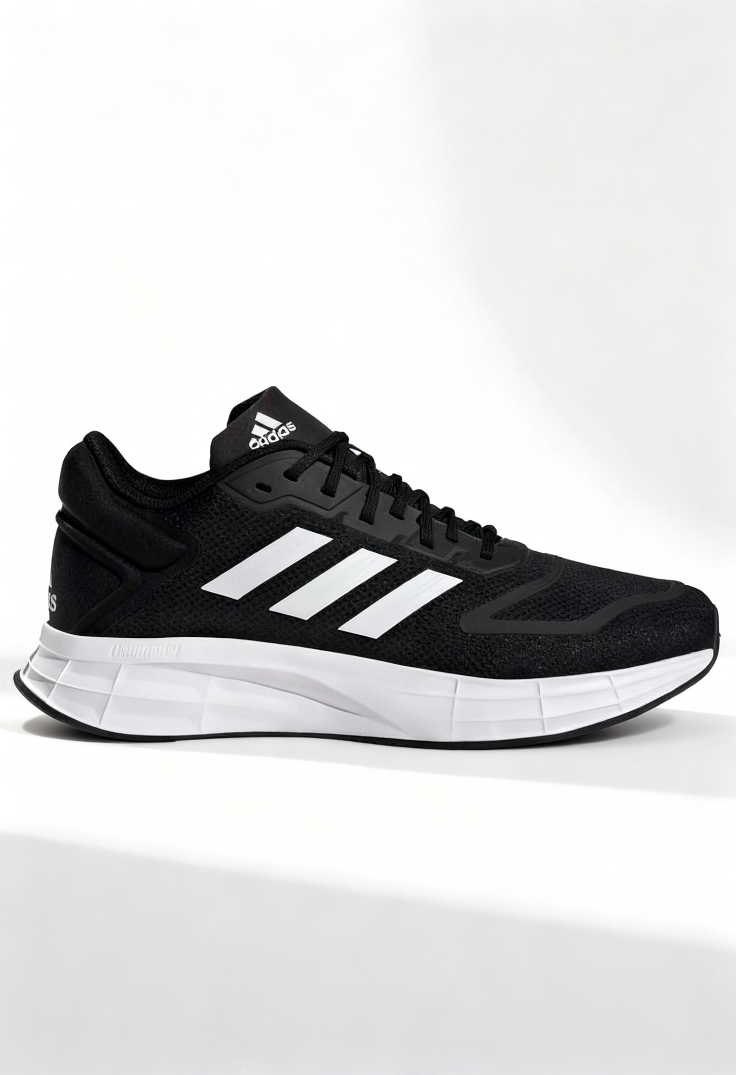 Brand new Adidas Duramo 10 men's running shoes in core black with white stripes side view.