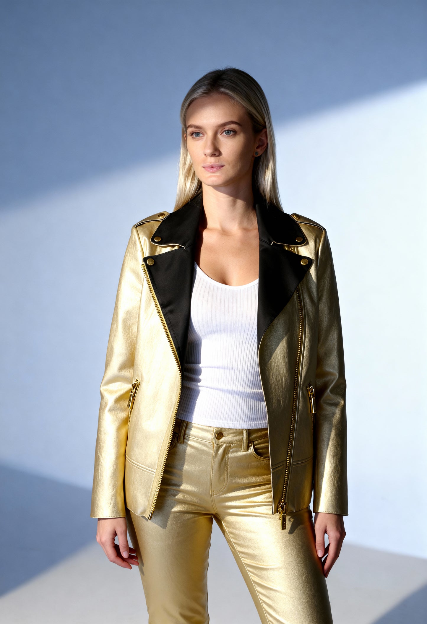 Front view of a woman wearing the gold Armani Exchange 6ZYB53_YNFTZ bomber jacket with black lapels.