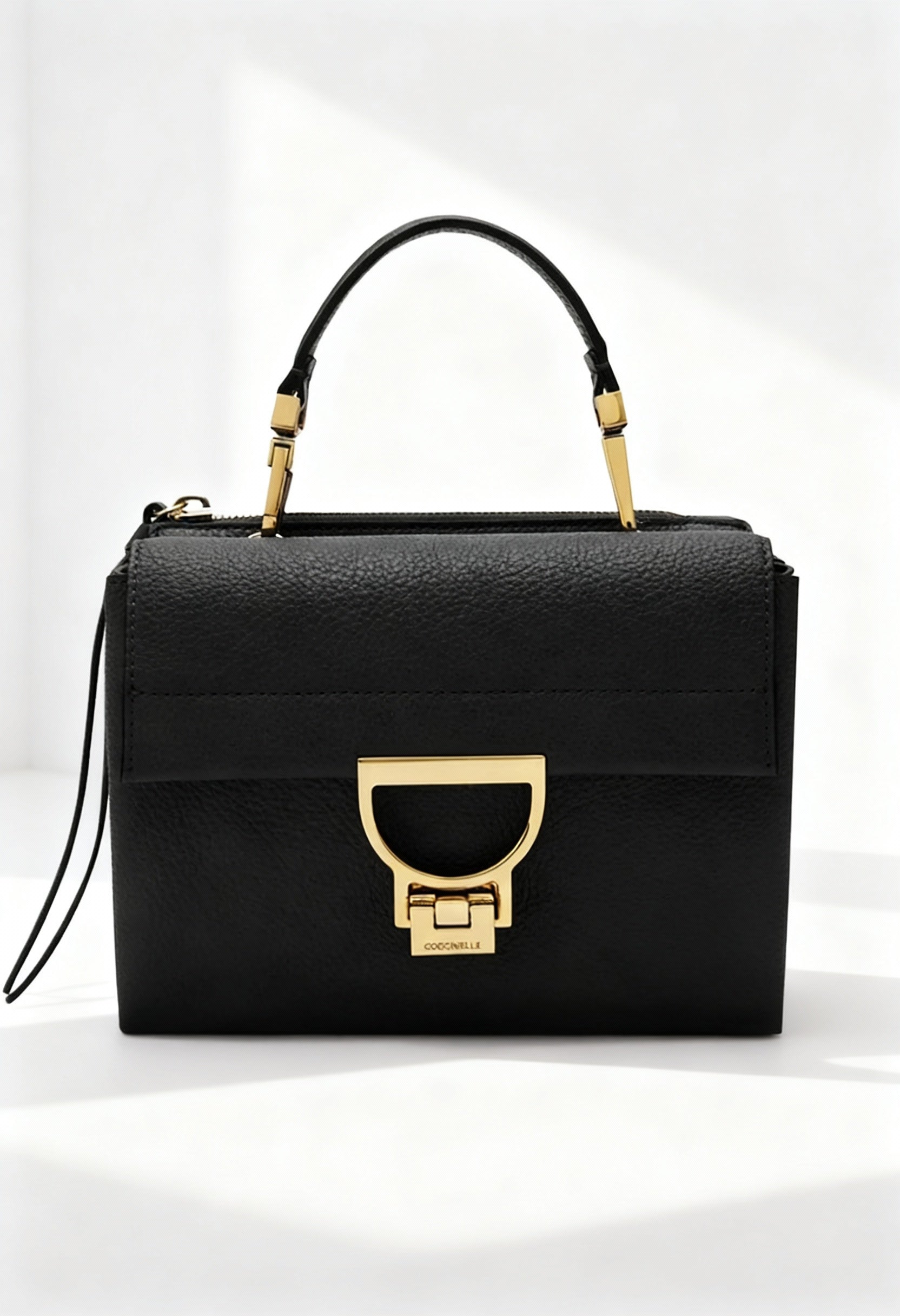 Coccinelle Arlettis black leather crossbody bag front view with gold clasp.