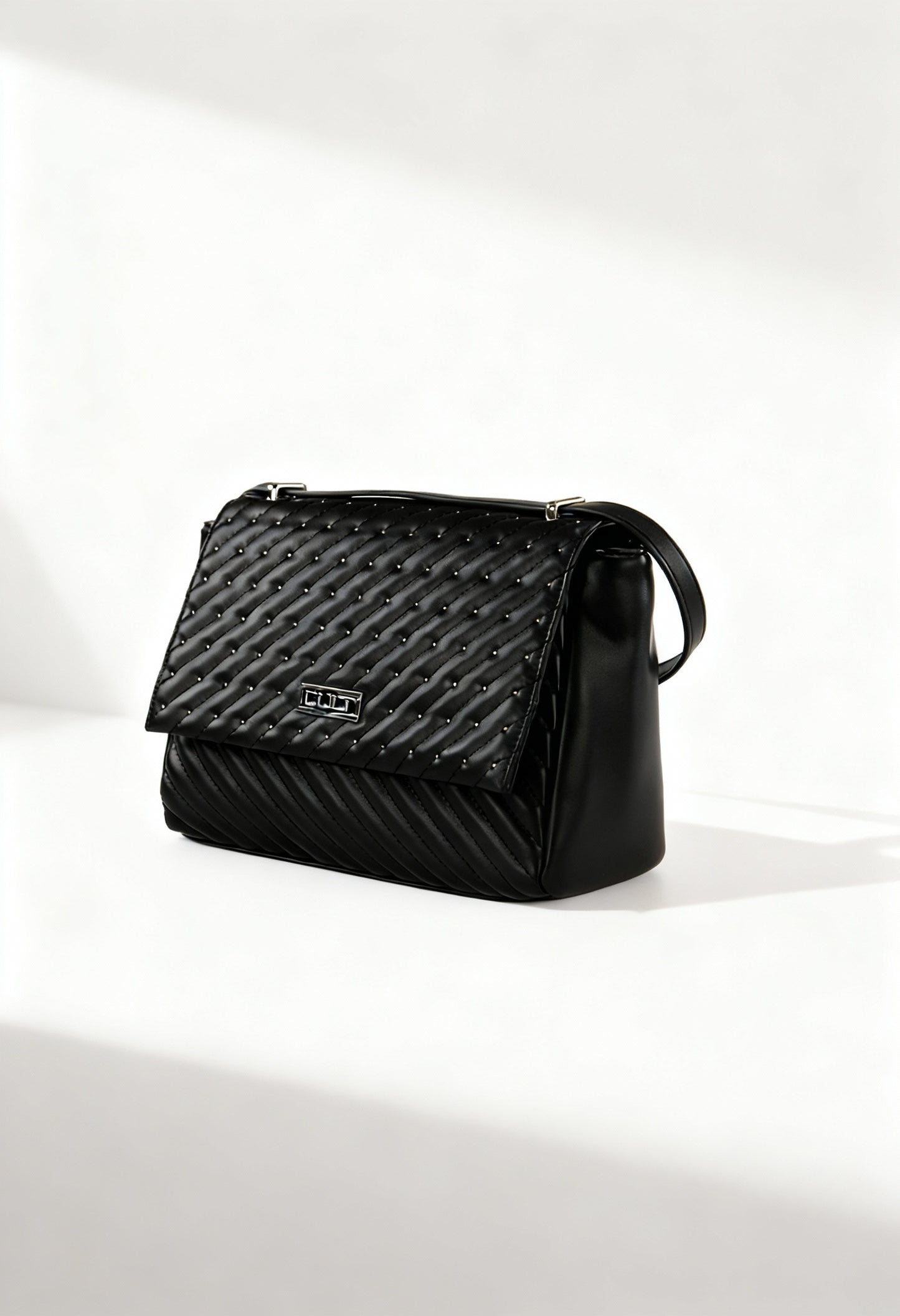 Front angle of the black Cult quilted shoulder bag with flap design and structured silhouette.