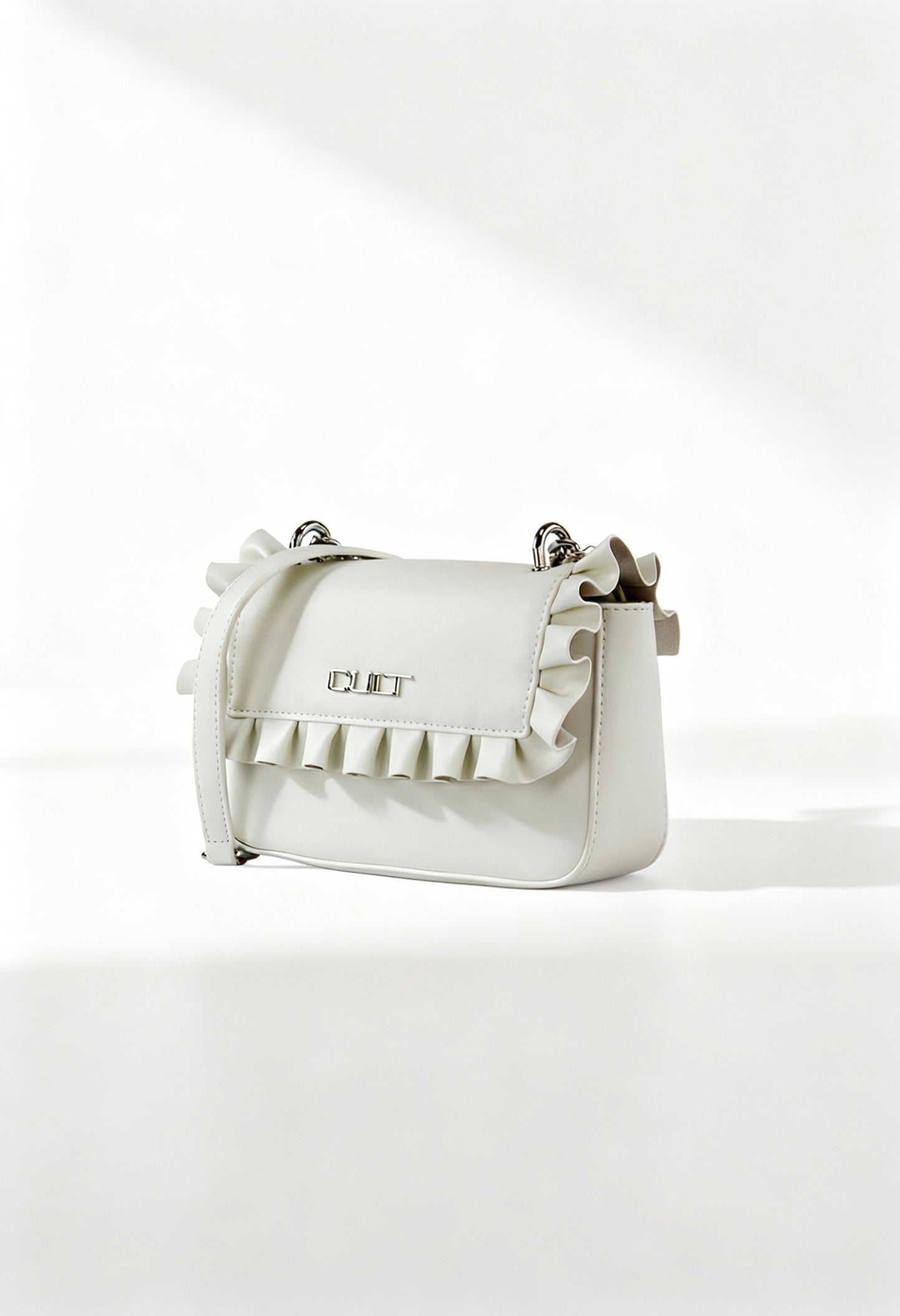 Front angle of the white Cult ruffled crossbody bag with flap design and structured silhouette.