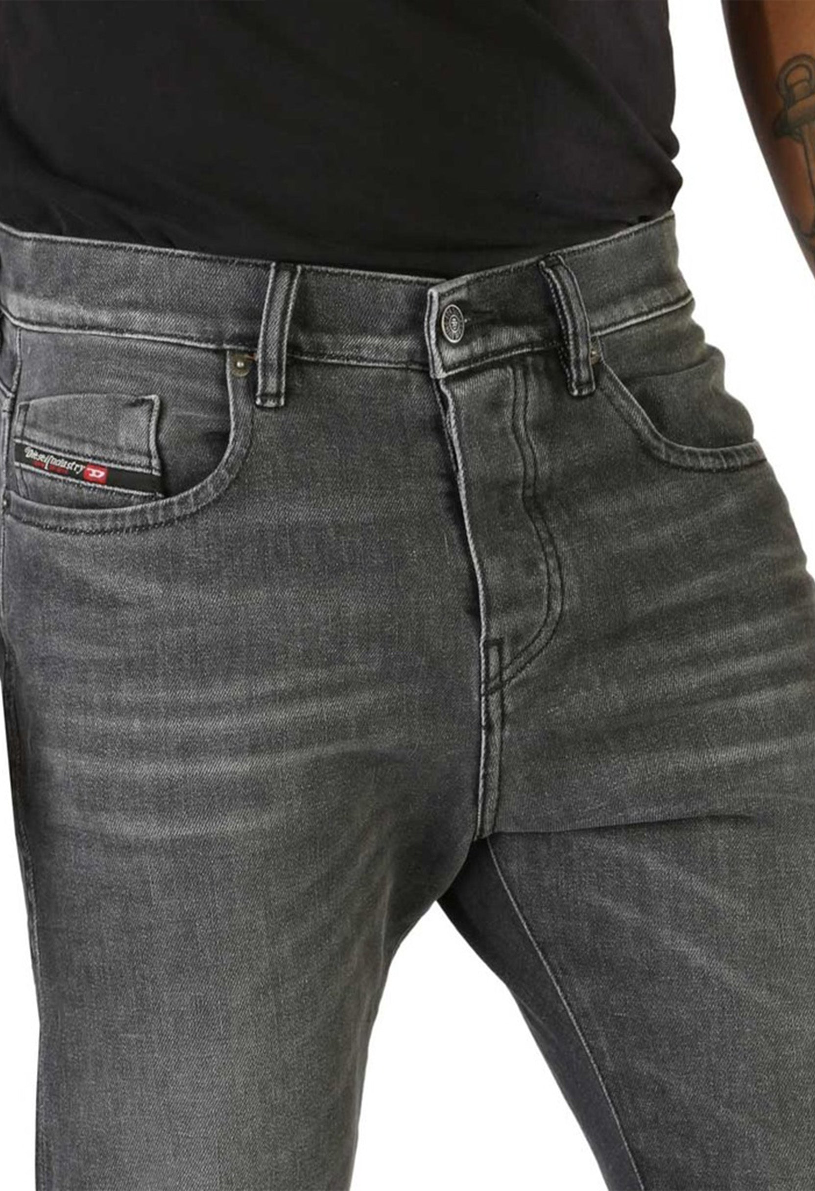 Diesel D-VIKER jeans close-up of front pocket, showing button fly and logo detail.