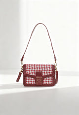 Front view of the burgundy Alison woman handbag placed on a light background with woven-effect pattern.