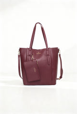 Front angled view of the Egon Von Furstenberg EVF1622-GIADA burgundy luxury shoulder bag with dual handles.