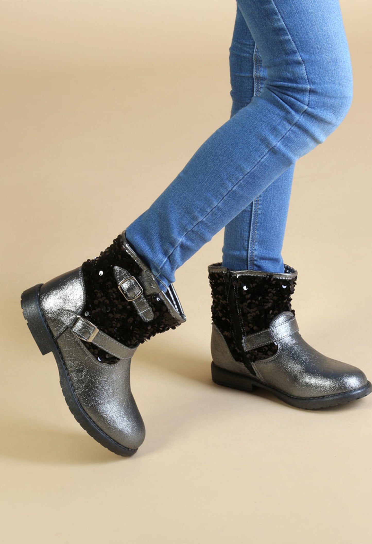 Girls' winter boots with side zip, showing fit on model's legs and jeans.