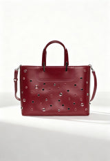 Front view of the Lamarthe PH104 burgundy leather handbag featuring metallic studs and double handles.