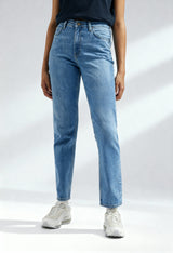 Front angled view of a woman wearing light blue Lee L30UOWB59 regular-fit jeans on a bright background.