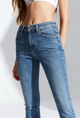 Front angled view of a woman wearing medium blue Lee L32SOVD43 skinny jeans on a bright background.