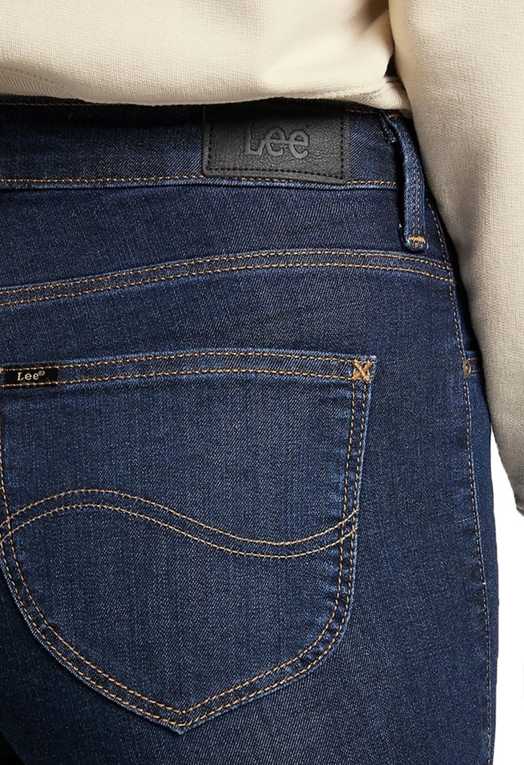 Close-up detail of the pocket stitching and texture of the dark blue Lee L626MDNX skinny jeans.