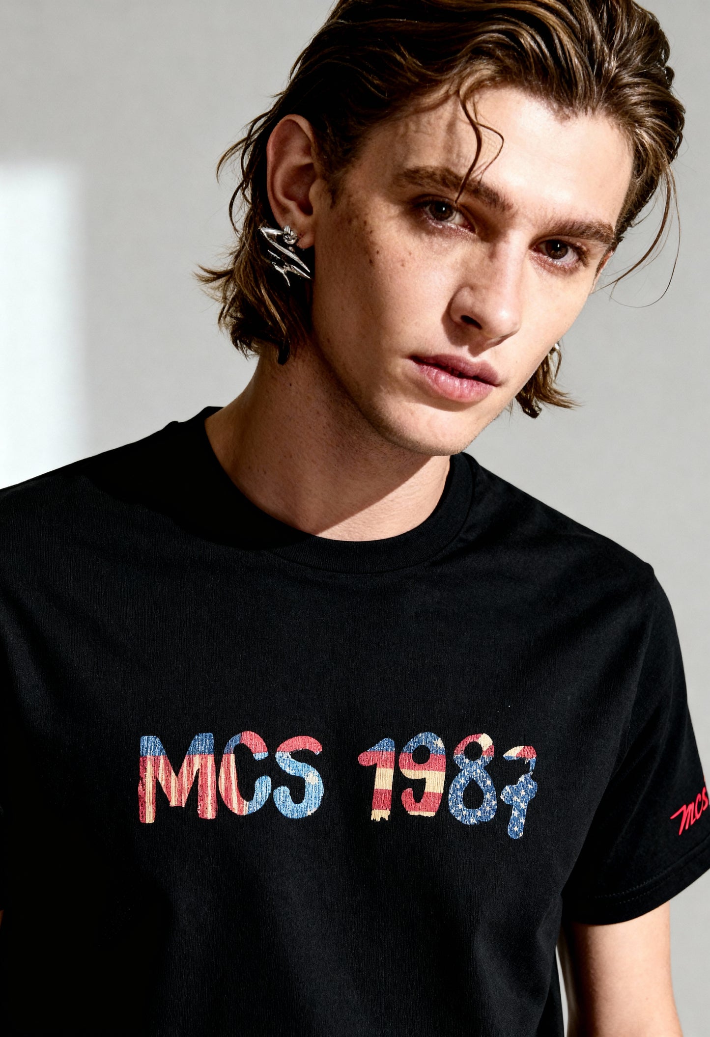 MCS 100% cotton men's t-shirt in black, short sleeves, visible front logo graphic.