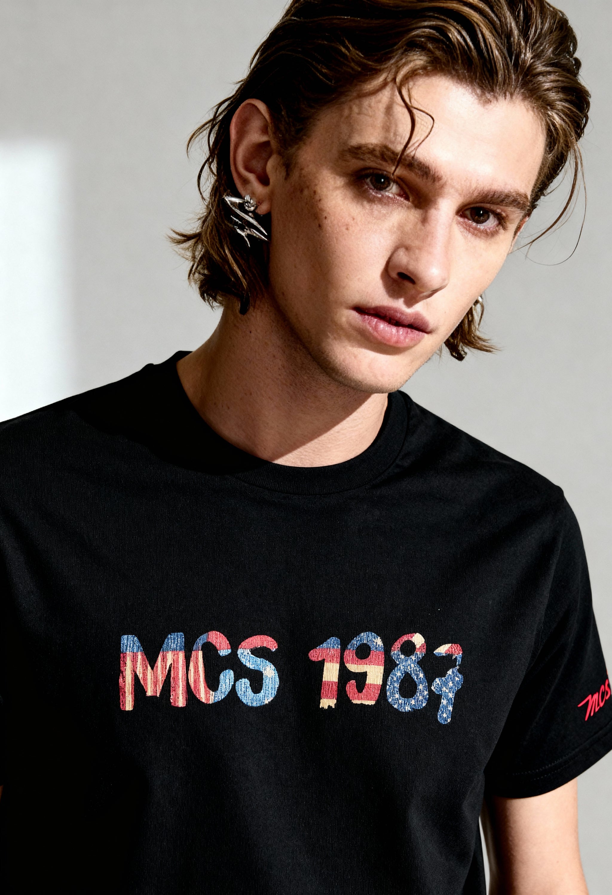 MCS 100% cotton men's t-shirt in black, short sleeves, visible front logo graphic.