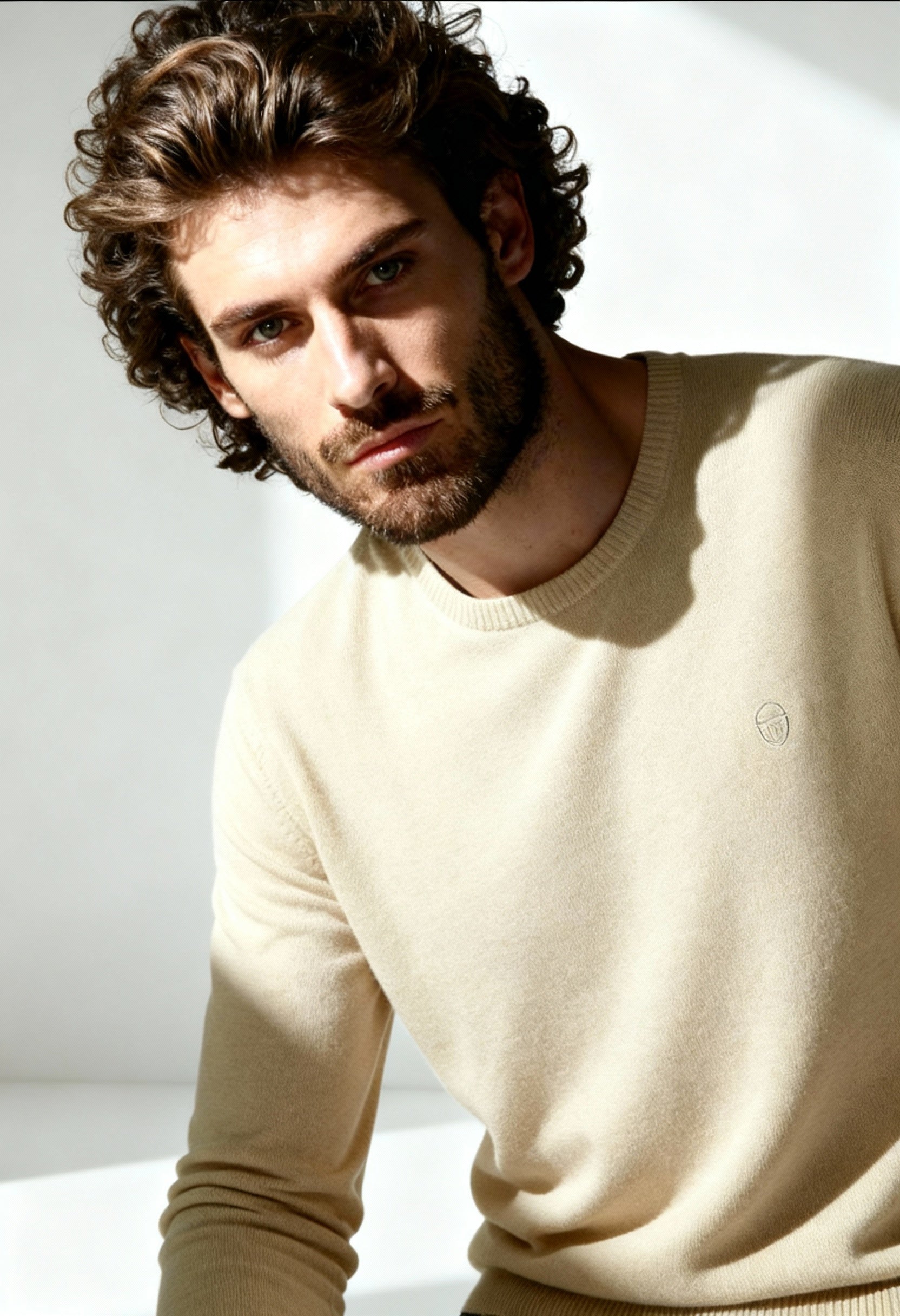 Sergio Tacchini men's 100% wool sweater in beige/off-white, worn by model, showing round neckline.