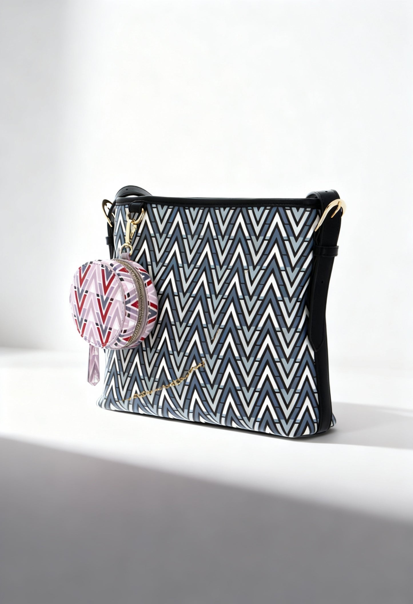 Front angled view of the Valentino TONIC-VBS69906 patterned crossbody bag with pink round coin pouch.