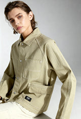 Studio front shot of a woman wearing the beige Vans VN000HJRD3Z1 cotton jacket.