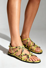 On-foot view of the yellow Xti multi-strap sandals with ankle buckle and open toe.